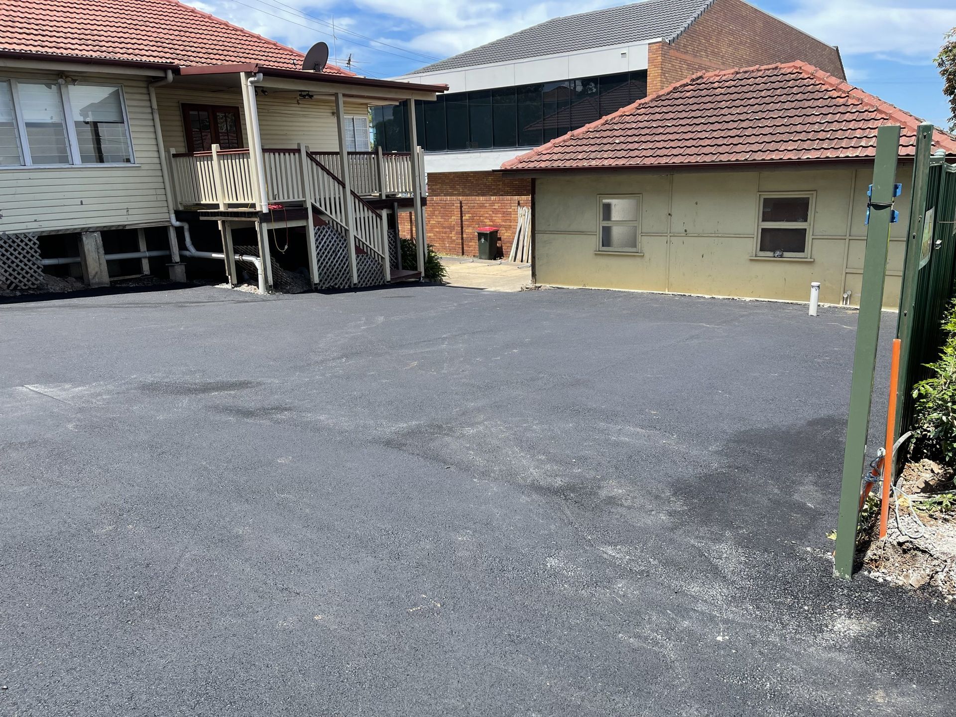 A Large Asphalt Parking Lot In Front Of A House – Chermside, QLD - Hands From Heaven Remedial Therapy Clinic
