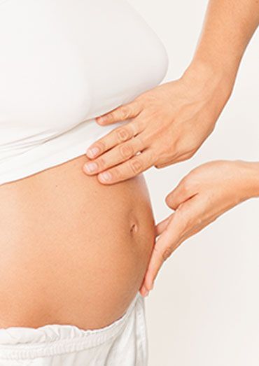 A Pregnant Woman Is Getting A Massage From Another Woman – Chermside, QLD - Hands From Heaven Remedial Therapy Clinic