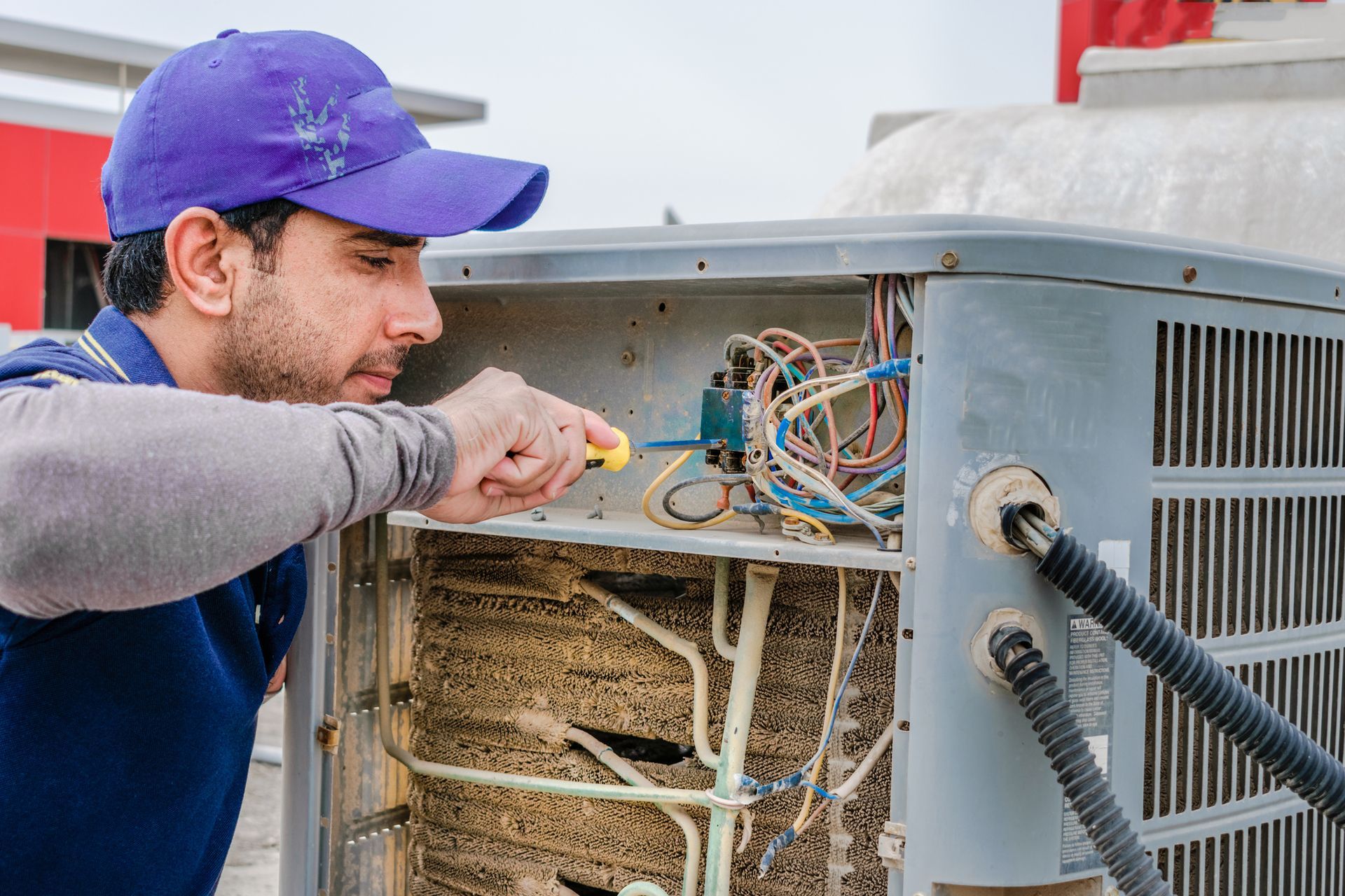 A person working on a machine|Air Conditioning Installation in Fayetteville NC |Foust Heating & Air