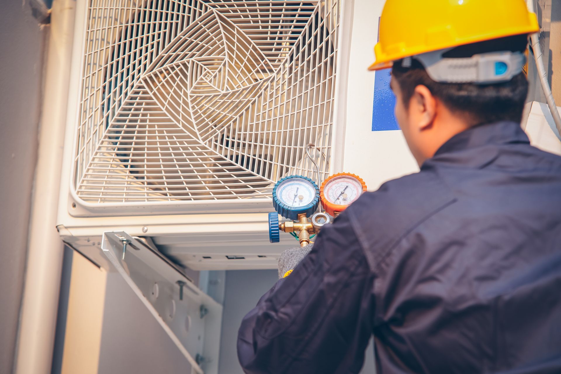 A commercial air conditioning contractor is inspecting an AC unit for maintenance and efficiency.