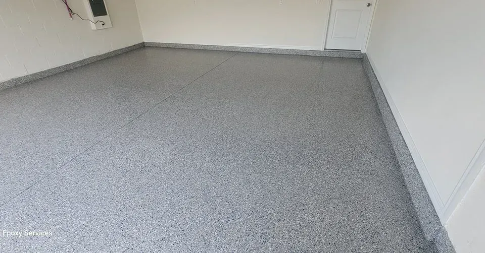Gray epoxy floor in a garage with white walls and trim.