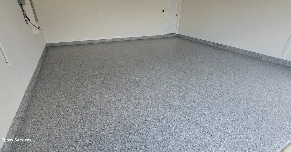 Gray epoxy-coated garage floor with flecks. White walls and base trim.