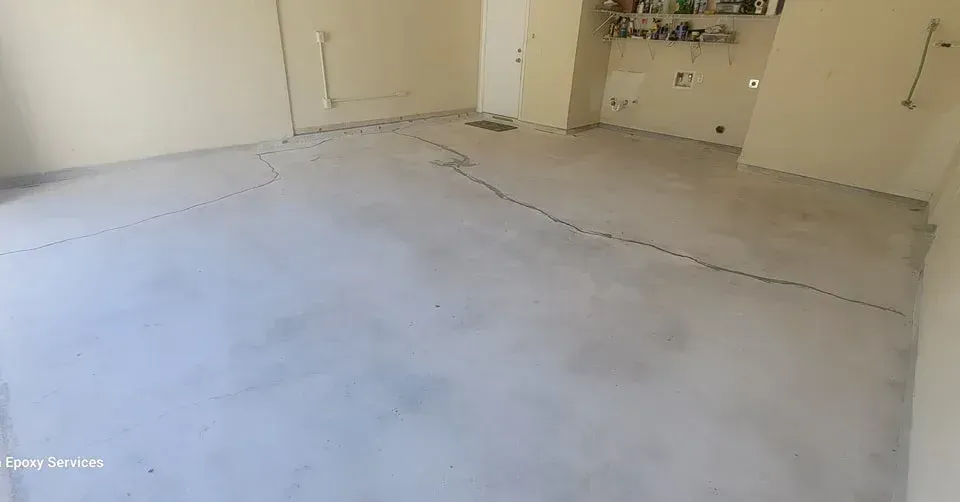 Empty room with a concrete floor and beige walls.