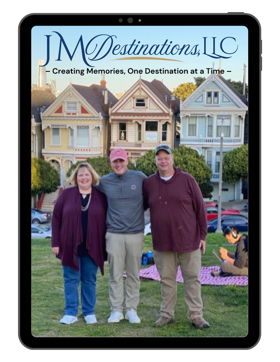 Three people posing outdoors in front of a house, with a JM Destinations, LLC sign above them.