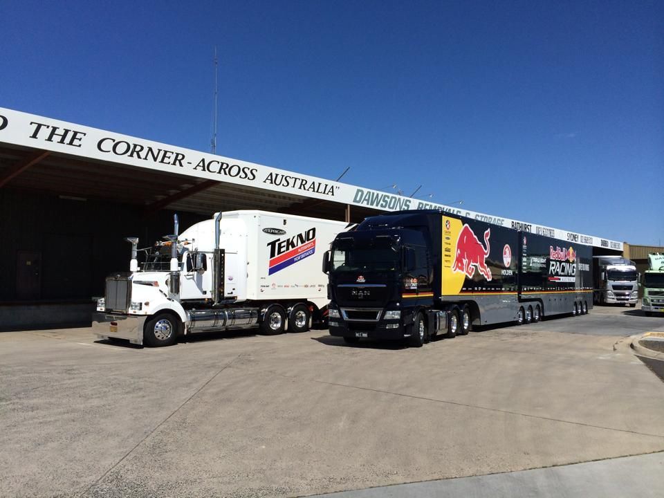 Two Semi-trucks Parked Next To A Building — Dawson's Removals In Bathurst, NSW