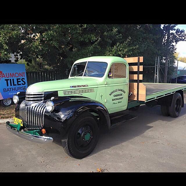 Vintage Green and Black Chevrolet Truck With Flatbed, Parked Outdoors — Dawson's Removals In Dubbo, NSW