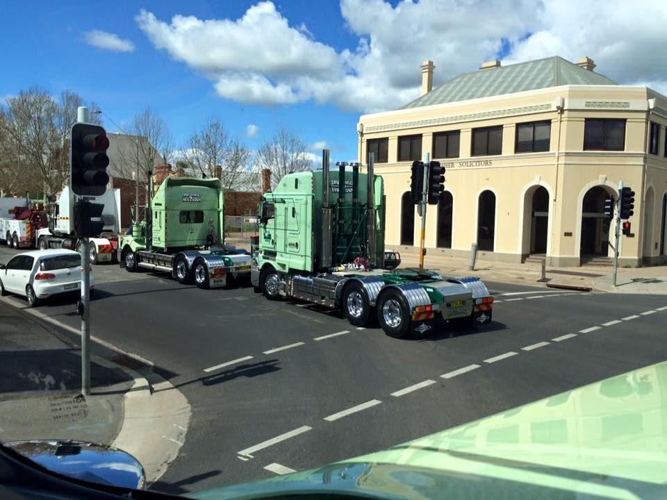 Two Green Semi-Trucks at An Intersection — Dawson's Removals In Kelso, NSW