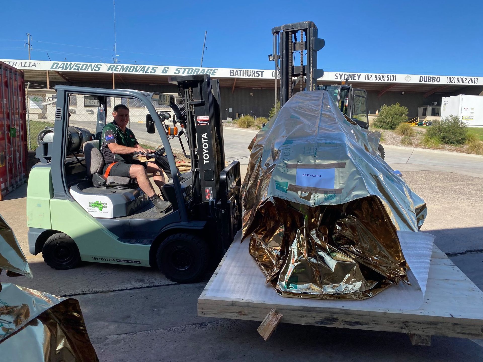 Forklift Operator Loading a Large, Foil-wrapped Item — Dawson's Removals In Wetherill Park, NSW