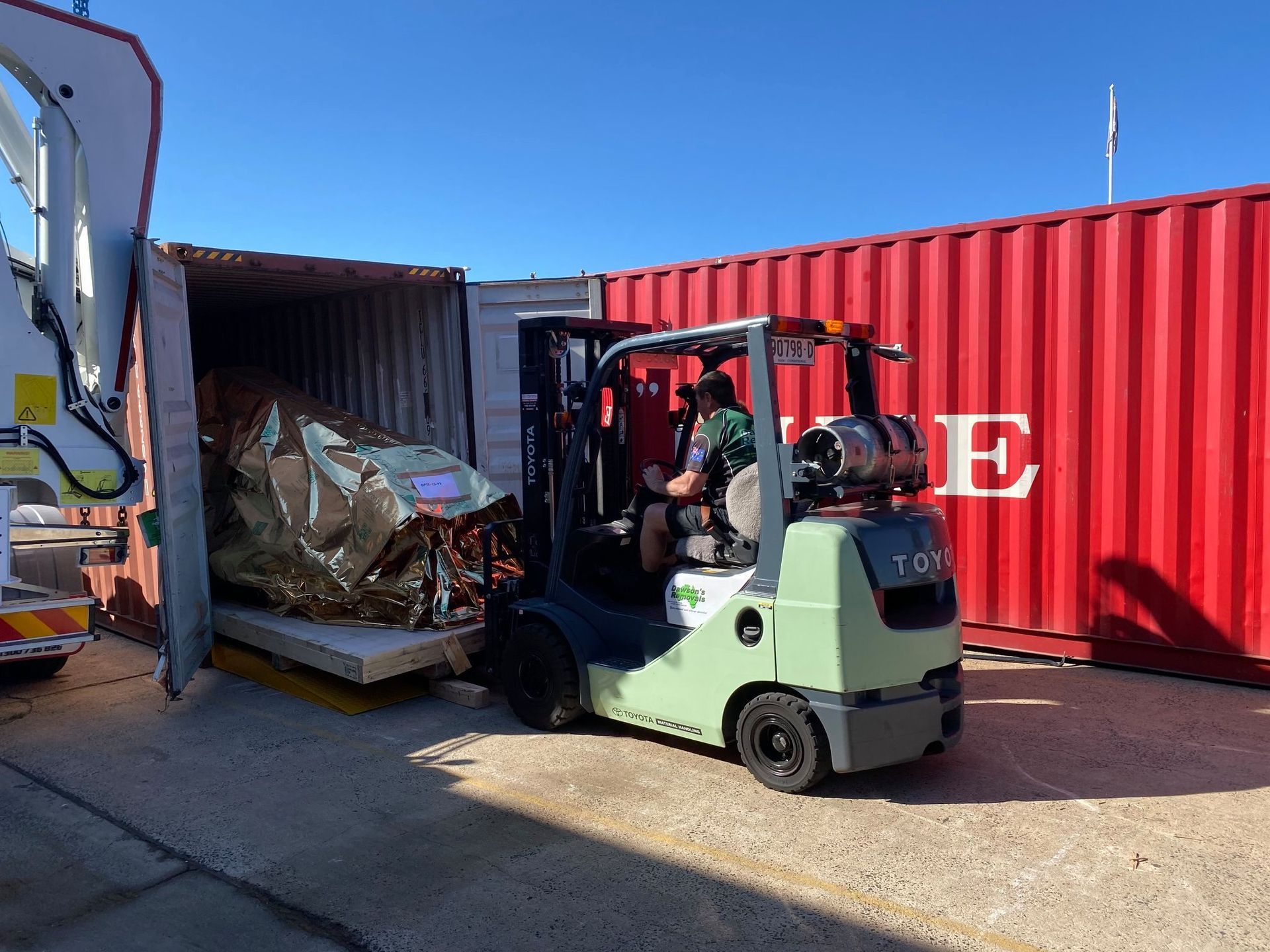 Green Semi-truck Loaded With Cargo on a Dirt Road — Dawson's Removals In Wetherill Park, NSW