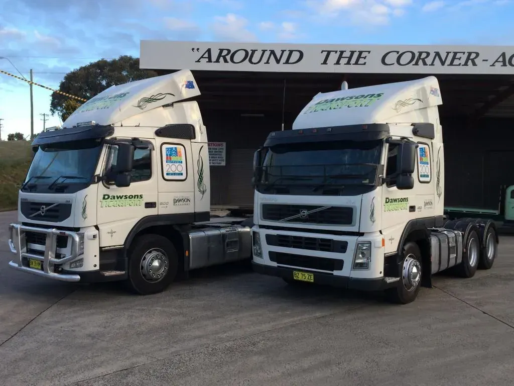 Two white Volvo Semi-trucks With Business Logos — Dawson's Removals In Kelso, NSW