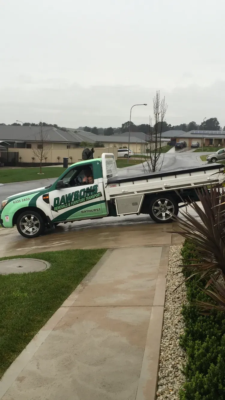 Green and White Landscaping Truck Parked on a Residential Driveway — Dawson's Removals In Kelso, NSW