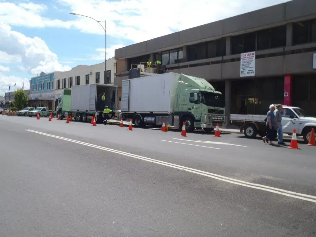 Two Semi-trucks Parked on a Street Lined With Cones — Dawson's Removals In Kelso, NSW