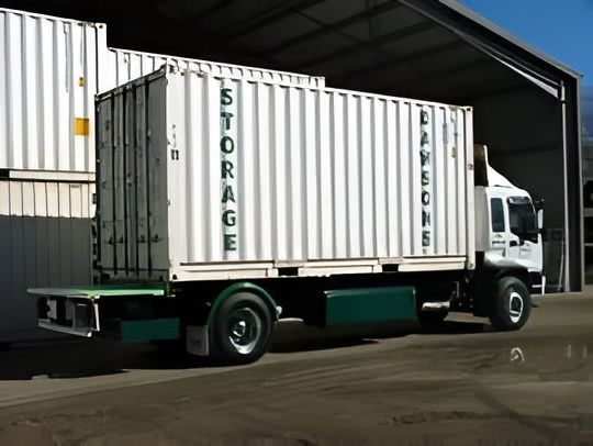 White Storage Container on a Green Truck — Dawson's Removals In Kelso, NSW
