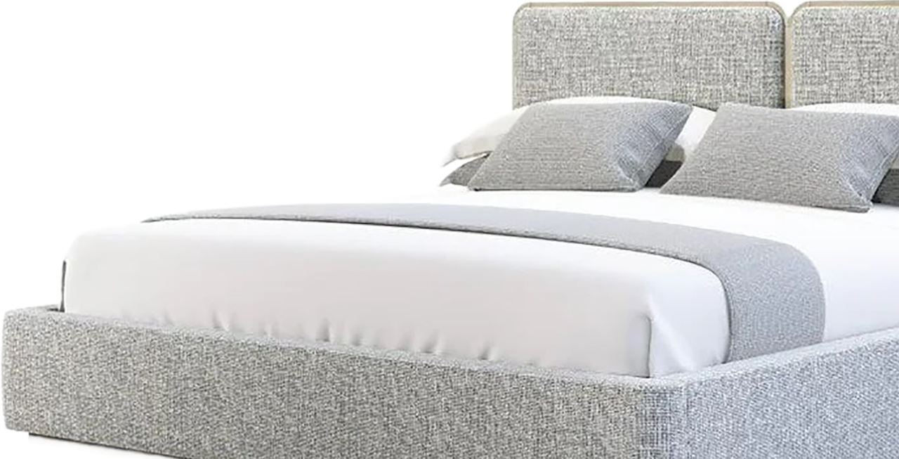 White upholstered bed with gray patterned headboard and matching pillows on a light background.
