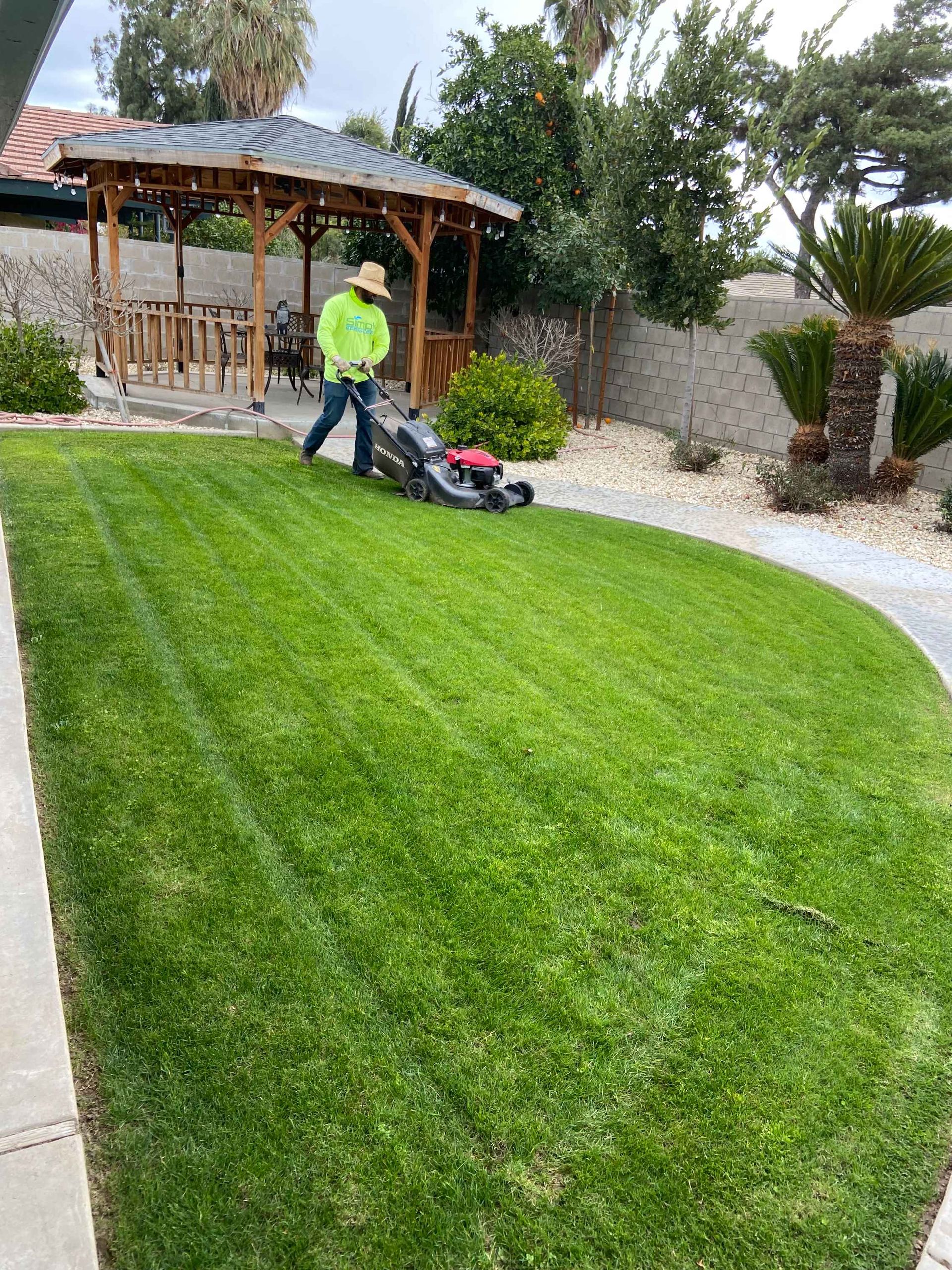 Person mowing a green lawn