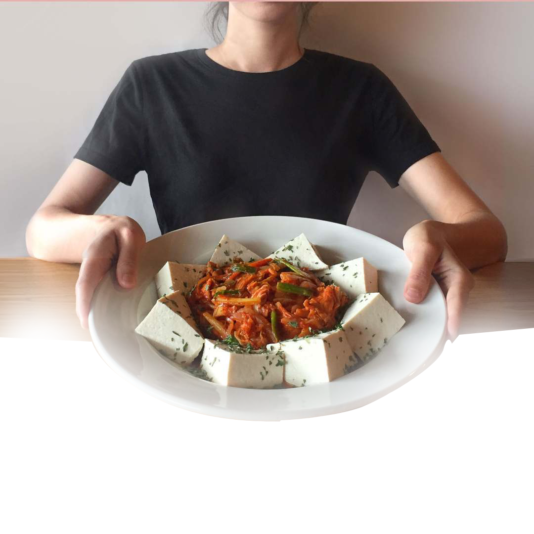 A woman is holding a plate of food in her hands