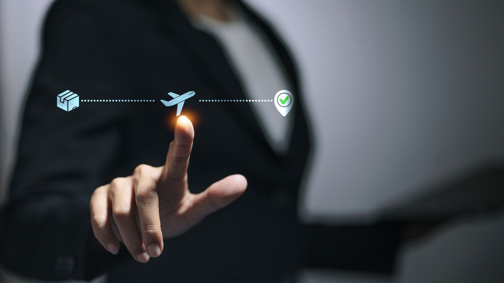Hand touching a glowing point on a virtual line with cloud, airplane, and map-pin icons