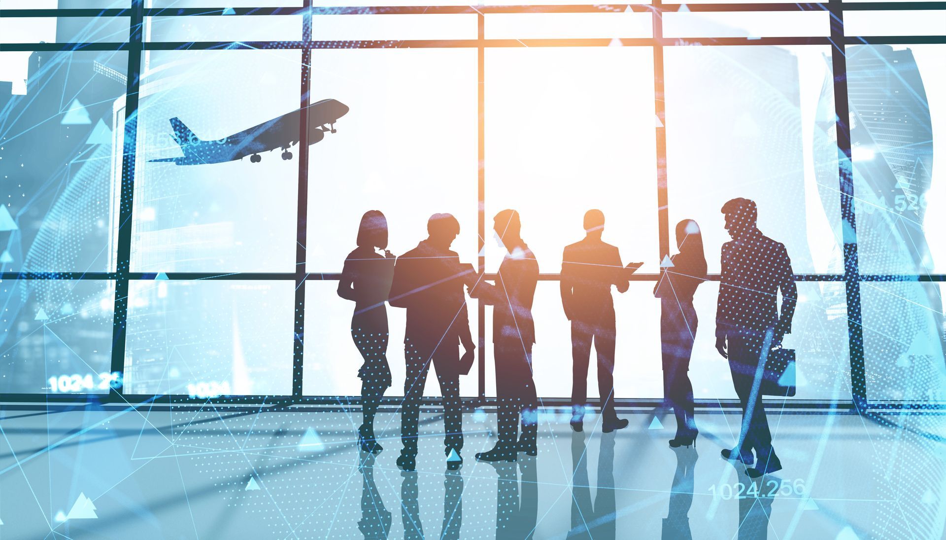 Silhouetted group of people standing in an airport terminal with a plane visible through the glass wall.