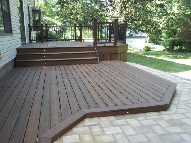 “Finished composite deck with dark railing, wide steps, and open backyard space by deck builders in Allentown, PA”