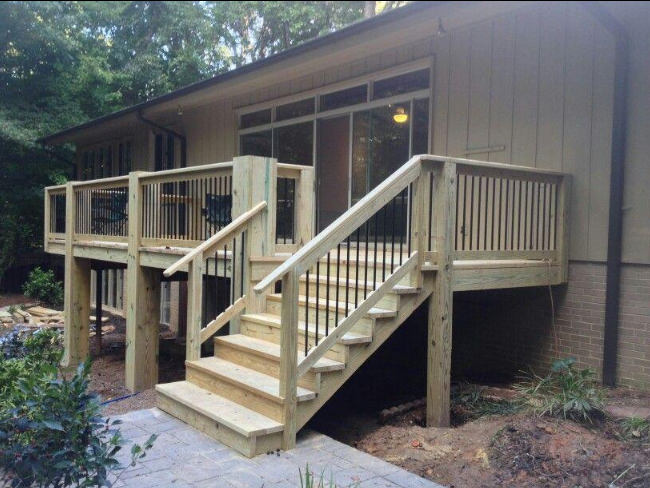 “Raised wooden deck with stairs and simple railings attached to a home by deck builders in Allentown, PA”