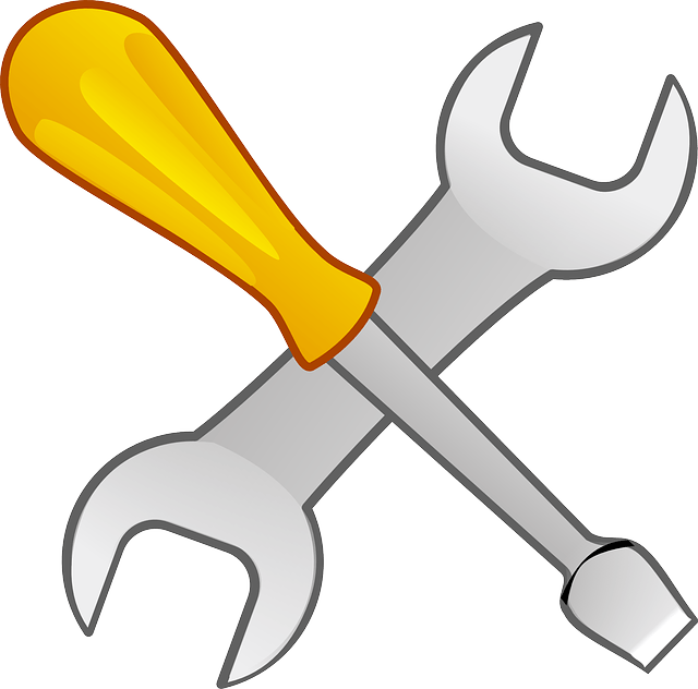 A crossed wrench and screwdriver with a yellow handle
