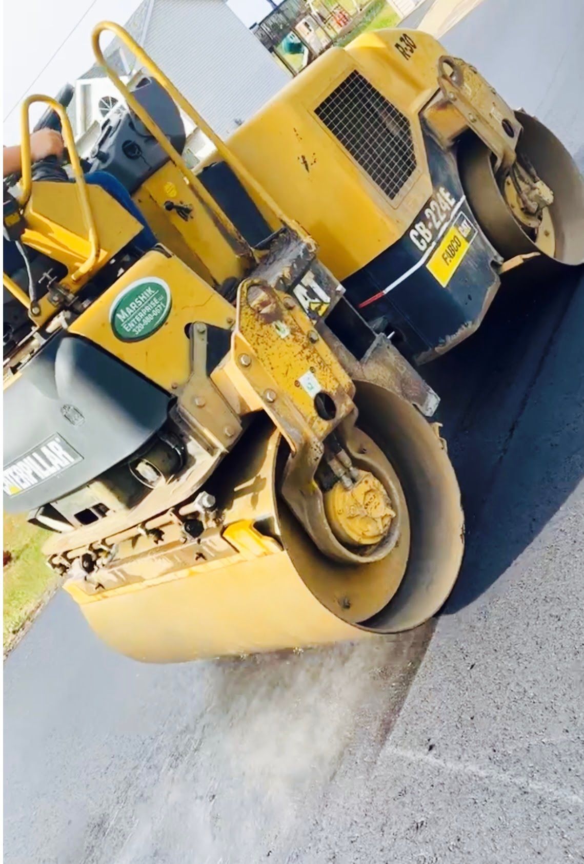 a yellow roller on a road