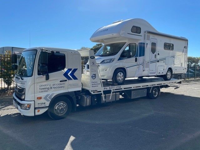 Campervan being transported on a flatbed trailer, highlighting towing in Geelong services for larger recreational vehicles.