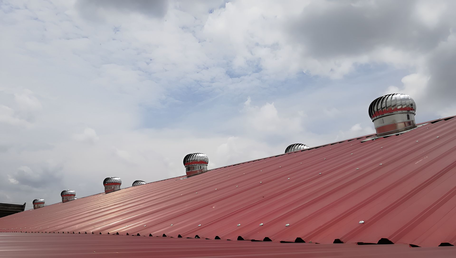 A Red Roof With a Lot of Whirlybirds on It — Nathan Parnell Roofing In Ulladulla, NSW
