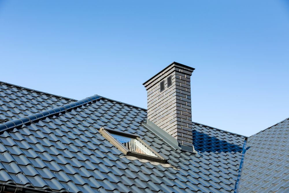 A Roof with a Chimney and a Skylight on it — Nathan Parnell Roofing In Vincentia, NSW