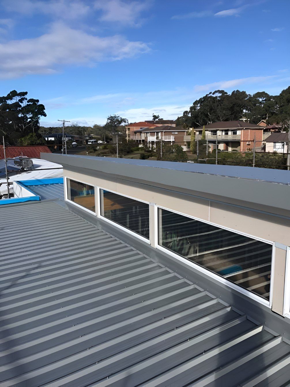 The Roof of a Building With a Lot of Windows — Nathan Parnell Roofing In Vincentia, NSW