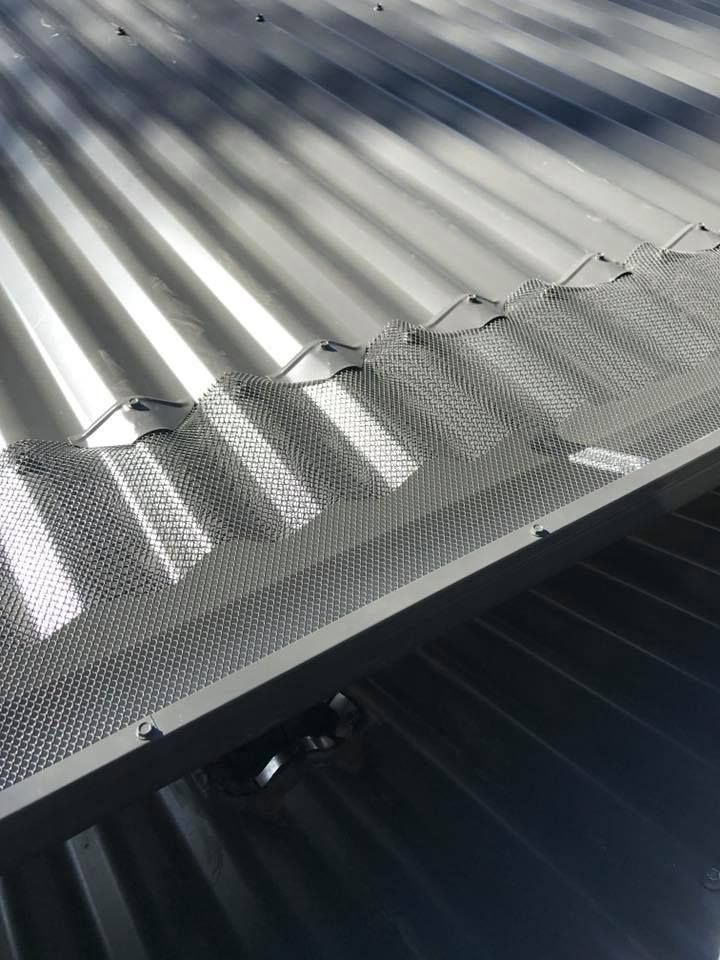 A Close Up of a Metal Roof With a Mesh on It — Nathan Parnell Roofing In Vincentia, NSW
