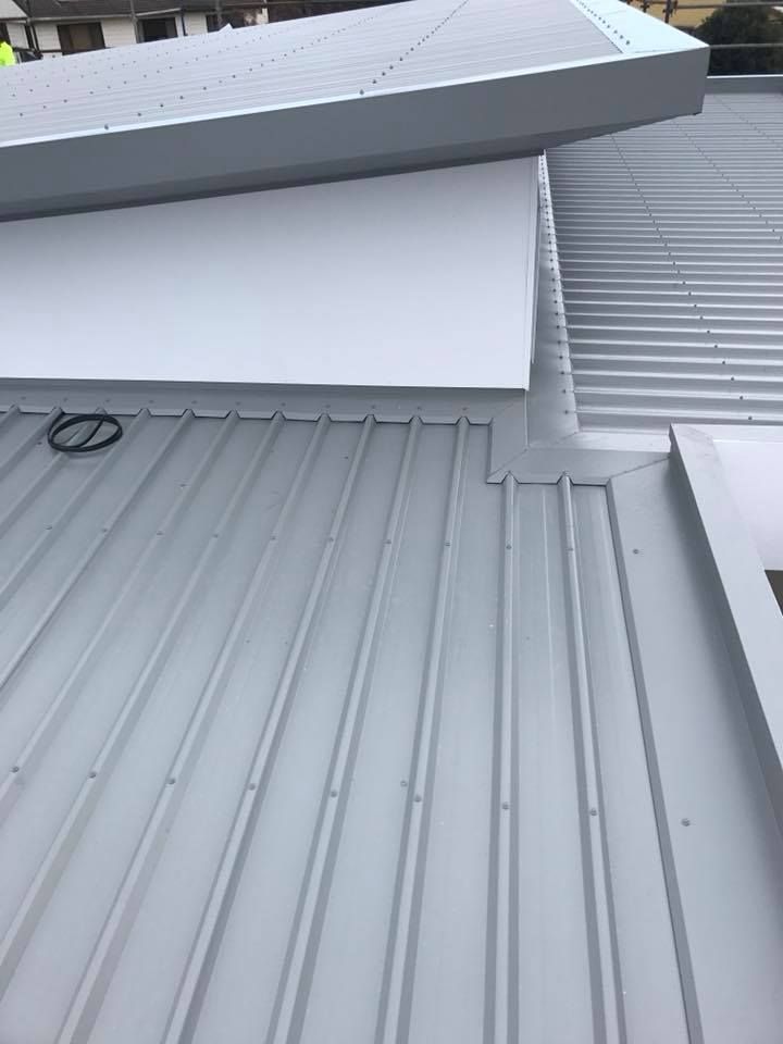 A Close Up of a Metal Roof on a Building — Nathan Parnell Roofing In Vincentia, NSW

