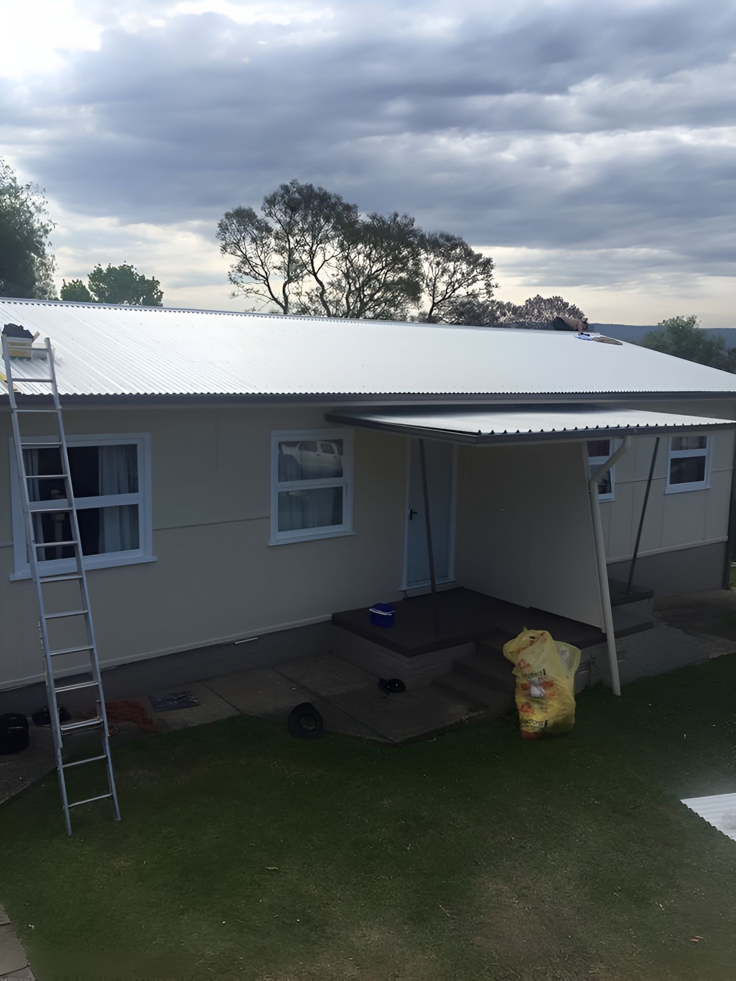 An Aerial View of a Metal Roof With a Blue Sky in the Background — Nathan Parnell Roofing In Ulladulla, NSW
