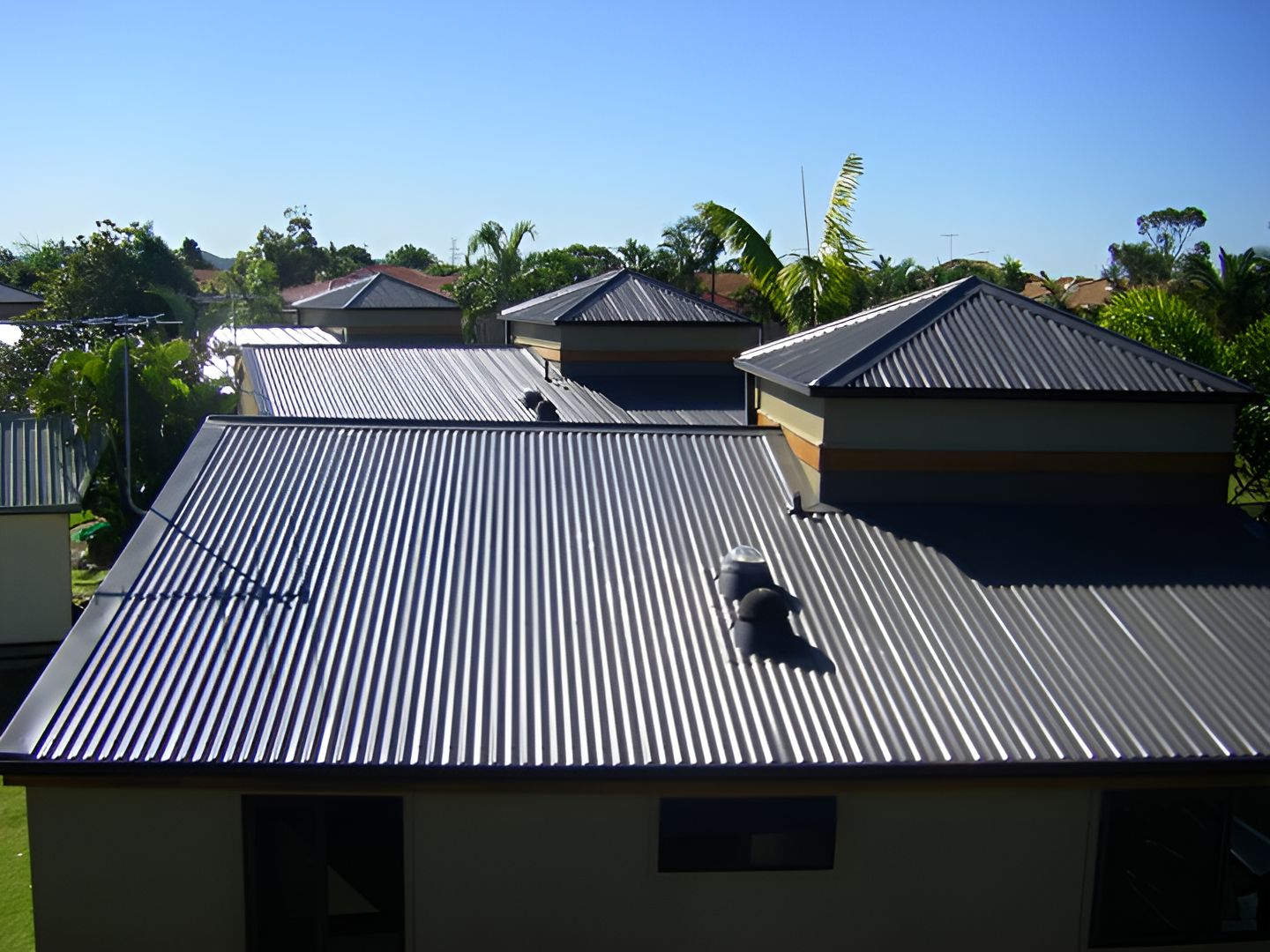A Dark Grey Roof With Other Roofs in The Background - Nathan Parnell Roofing In Sussex Inlet, NSW