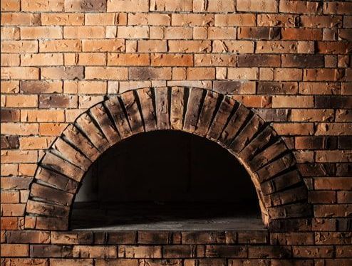 A Brick Wall With a Hole in the Middle of It — Nathan Parnell Roofing In Ulladulla, NSW