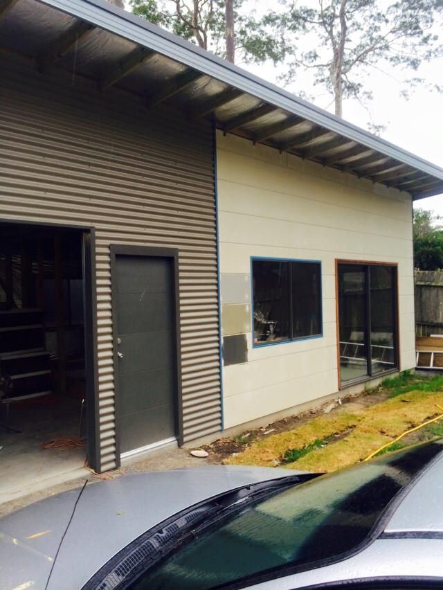 A Car is Parked in Front of a House That is Under Construction — Nathan Parnell Roofing In Vincentia, NSW