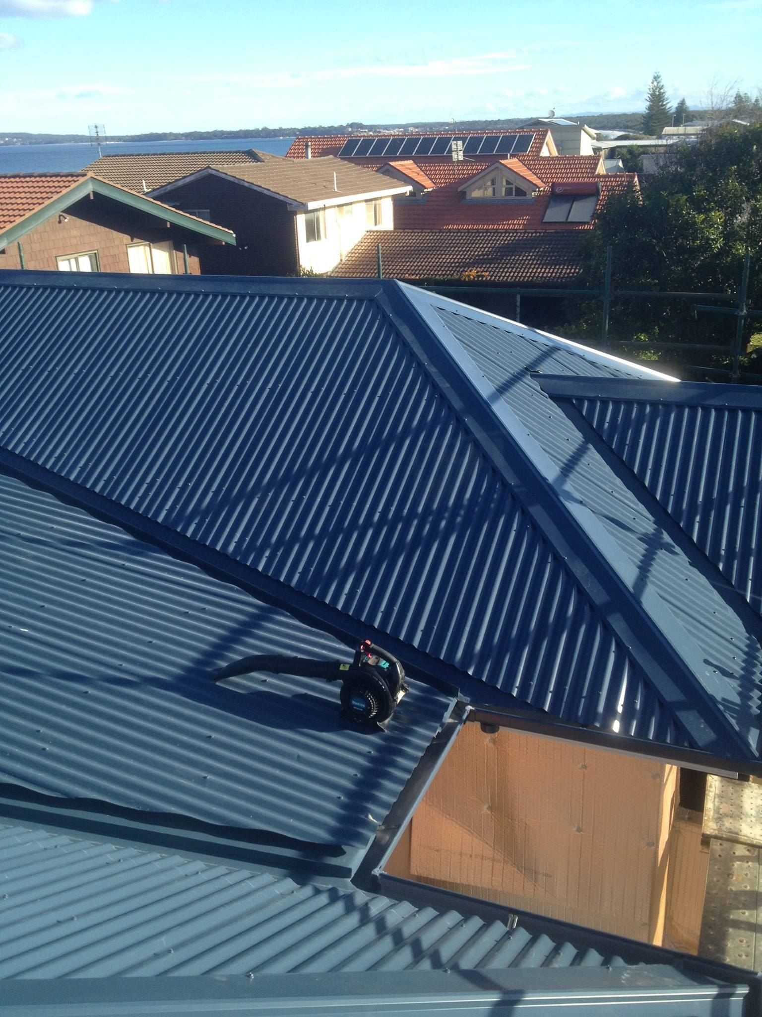 A Roof With a View of a City and a Body of Water — Nathan Parnell Roofing In Vincentia, NSW