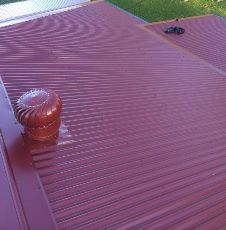 A Red Roof With a Wind Turbine on Top of It — Nathan Parnell Roofing In Vincentia, NSW