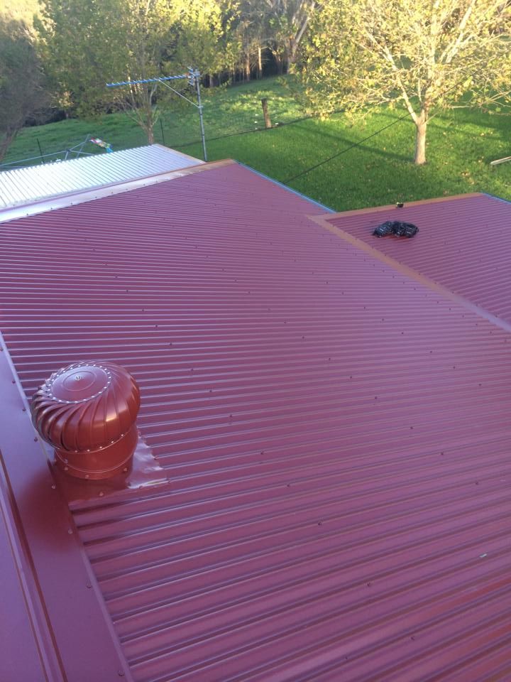 A Red Roof With a Wind Turbine on Top of It — Nathan Parnell Roofing In Vincentia, NSW