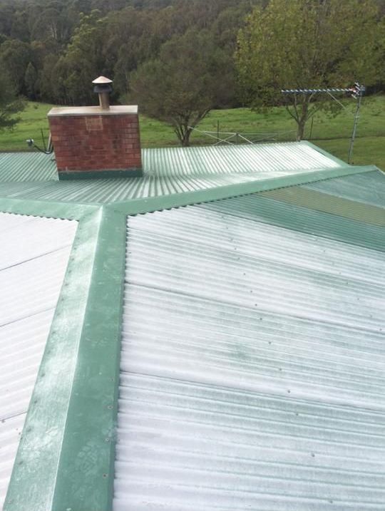 A Green Roof With a Chimney on Top of It — Nathan Parnell Roofing In Vincentia, NSW