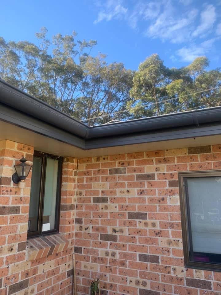 A Brick House With a Window and a Gutter on the Roof — Nathan Parnell Roofing In Vincentia, NSW