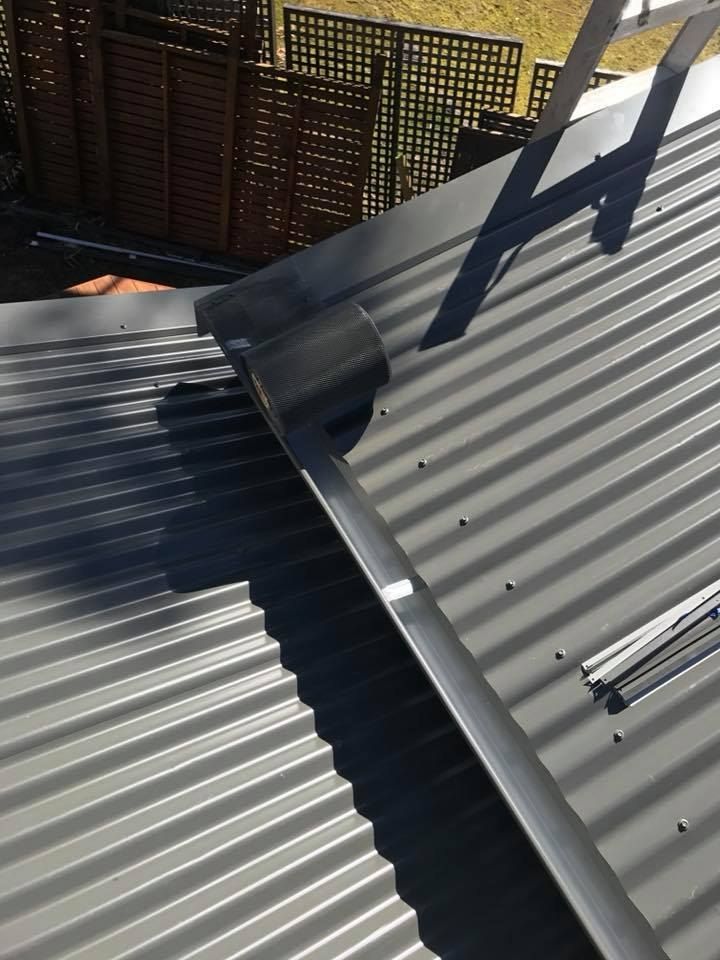 A Close Up of a Roof With a Ladder on It — Nathan Parnell Roofing In Vincentia, NSW