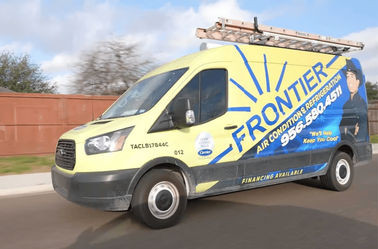 A light yellow Ford Transit work van for Frontier Air Conditioning & Refrigeration parked on a suburban street.