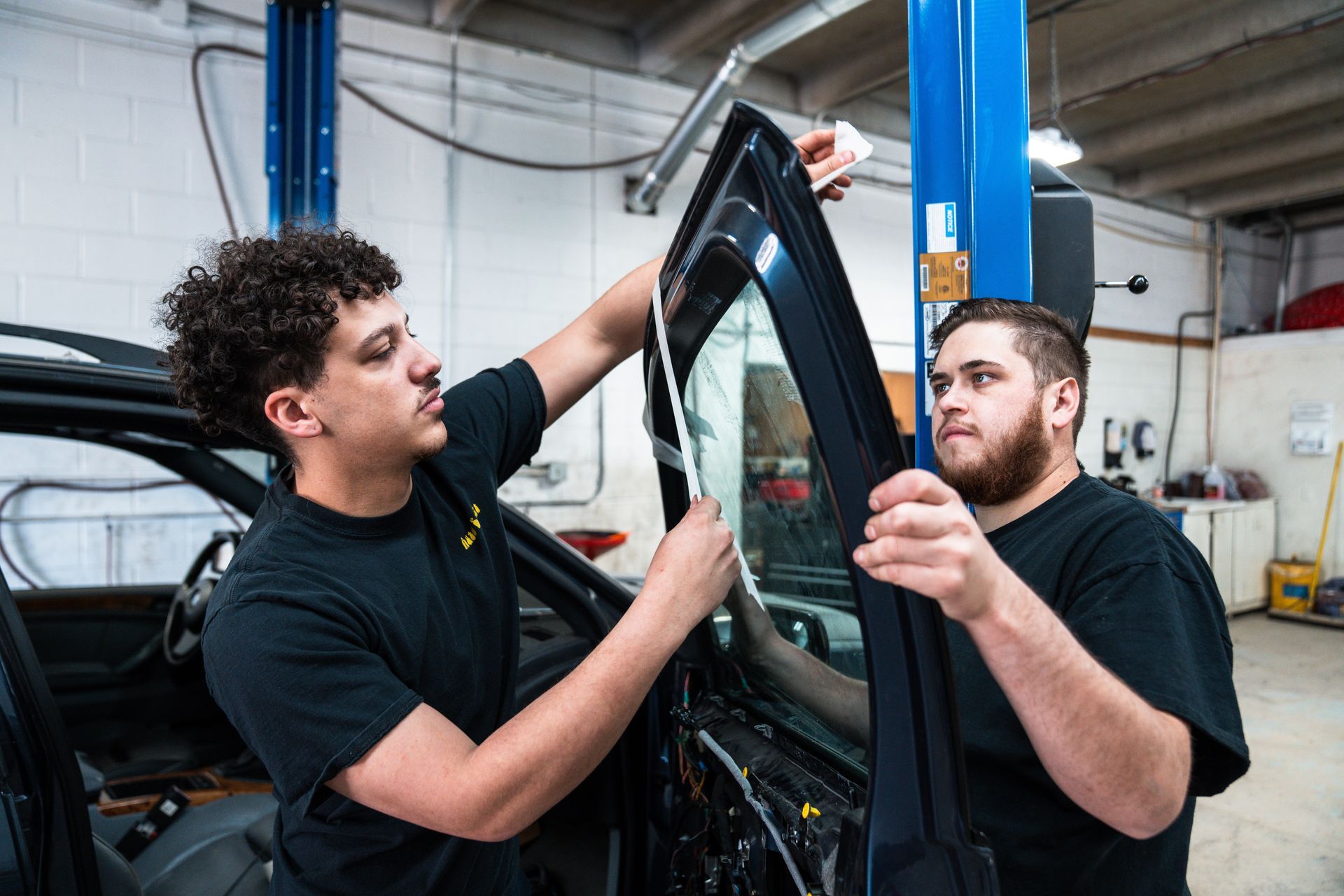 Two Technicians Performing Car Window Tinting | AutoSport