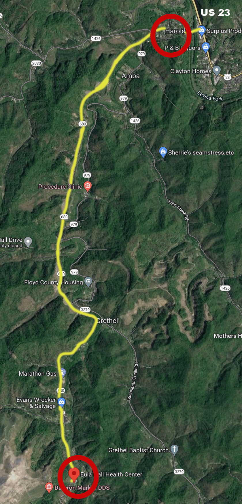 Satellite map of a winding mountain road with two red-circled points, one near the top and one near the bottom