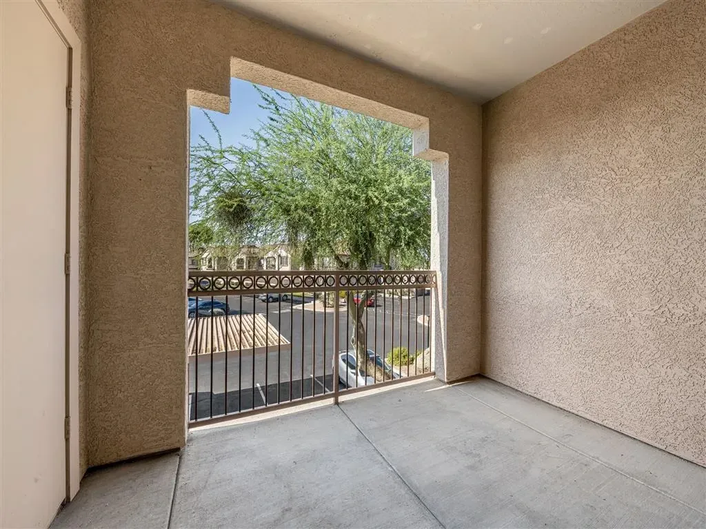 View from apartment balcony to parking lot and surrounding buildings