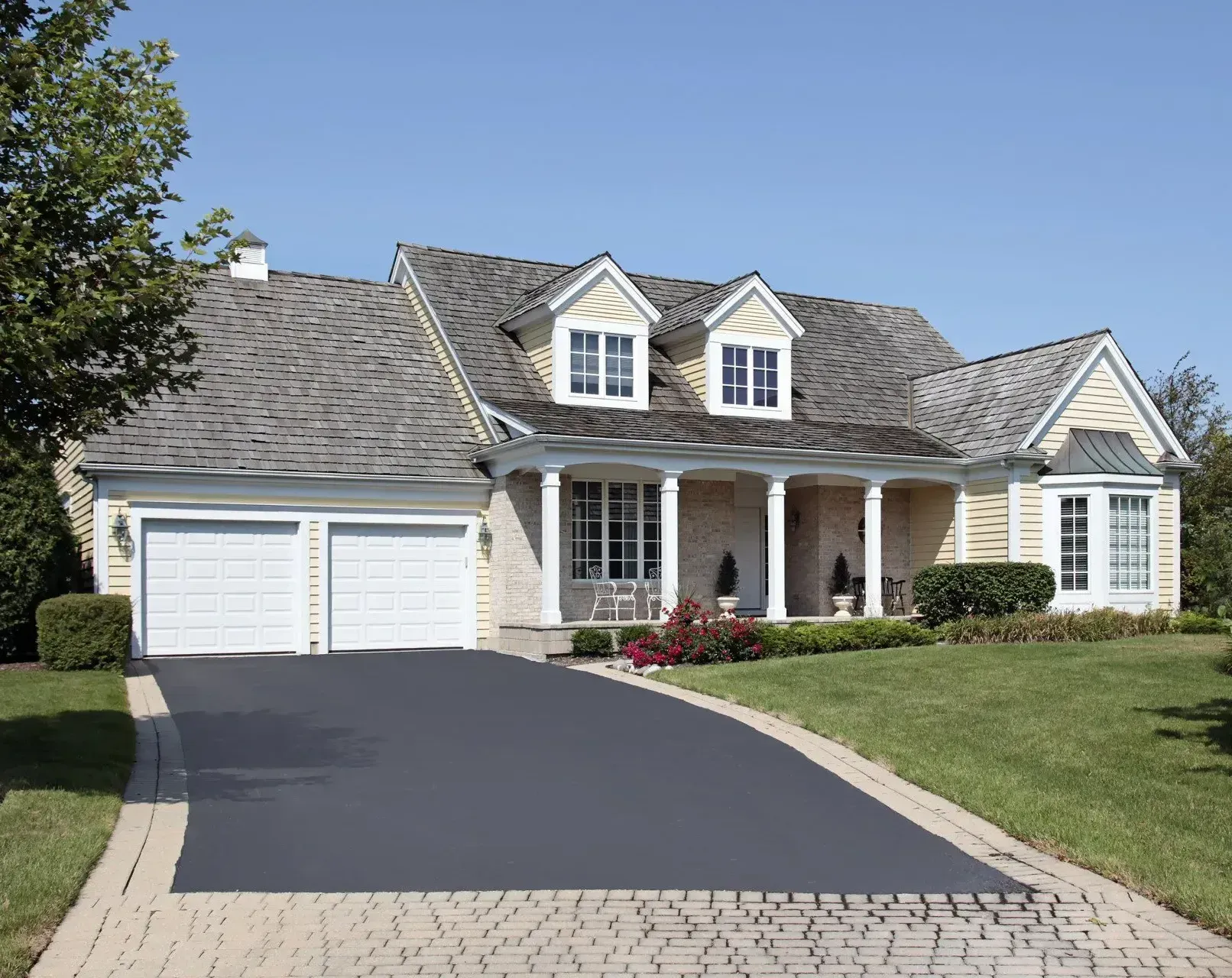 A large house with a large driveway leading to it