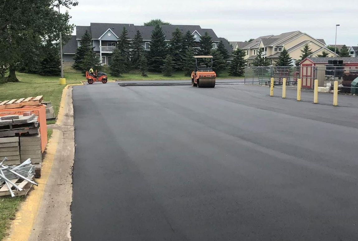 A road is being paved in a parking lot.