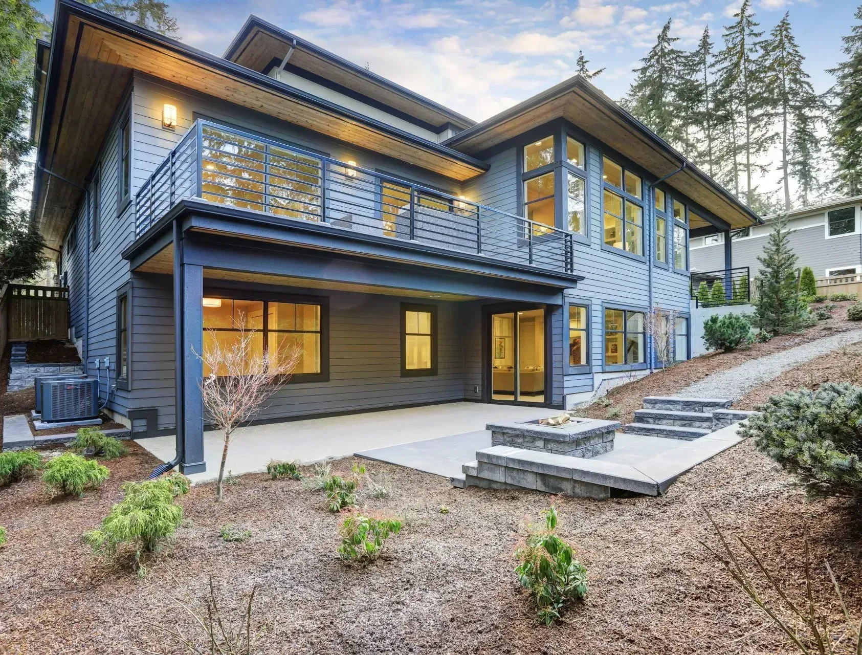 A large house with a lot of windows and a patio in front of it.