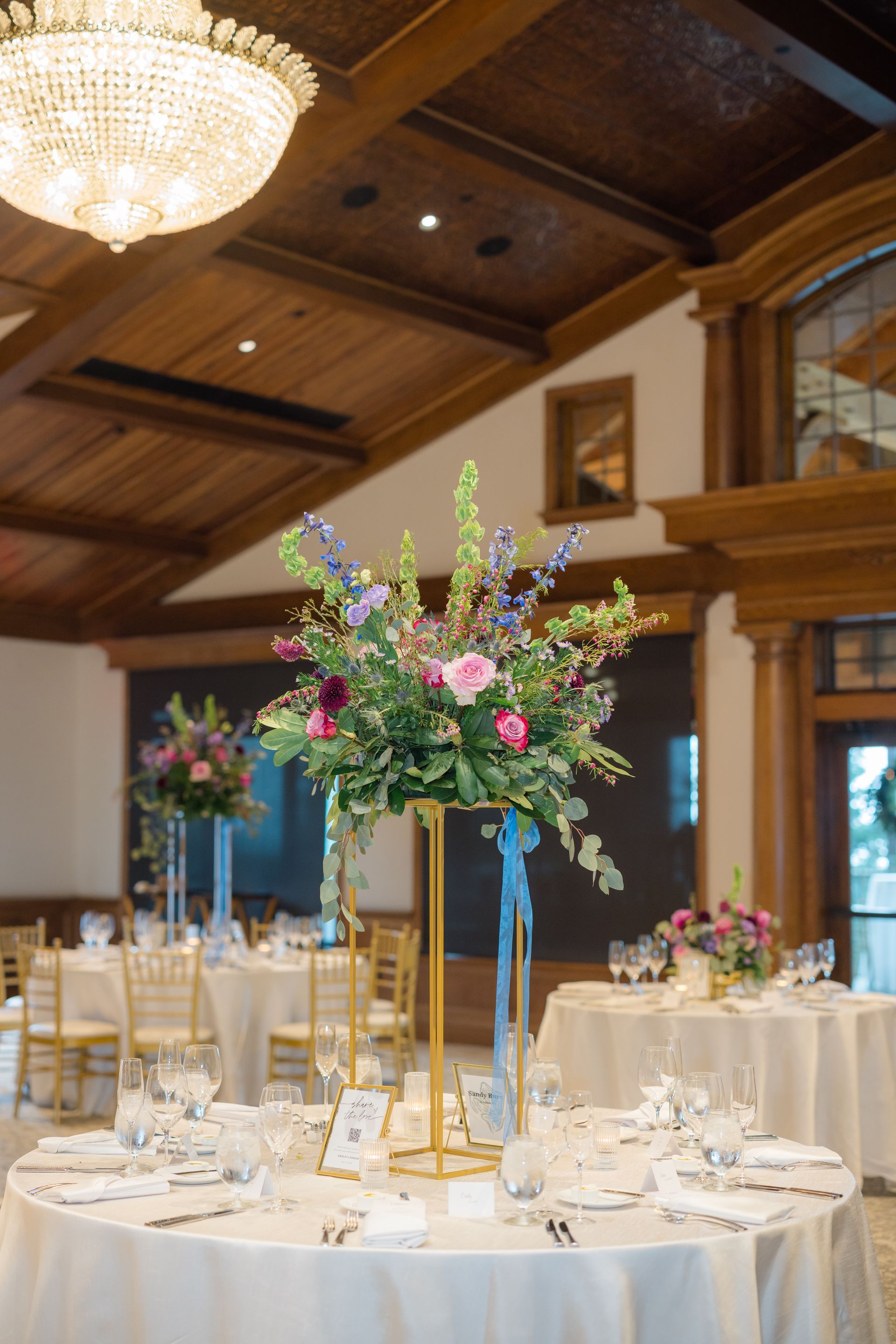 Beautiful table setting with elegant floral centerpiece in the Grand Ballroom at The Starting Gate 